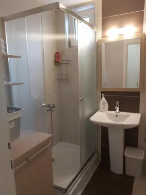 a small bathroom with a shower and a sink at Sky lux apartment Vracar in Belgrade