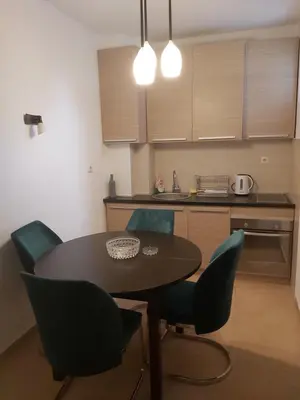 a kitchen with a table and chairs in a room at Sky lux apartment Vracar in Belgrade