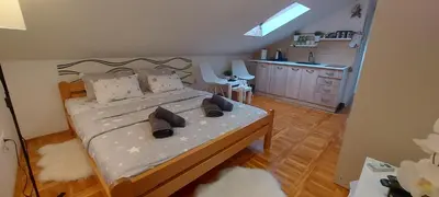 a bedroom with a bed with shoes on it at Apartman 