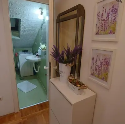 a bathroom with a sink and a mirror at Apartman 