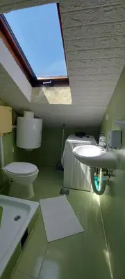 a bathroom with a sink and a toilet at Apartman 
