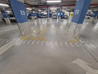a parking garage with a parking lot with cars parked at Aqua Royal BW apartment in Sajmište