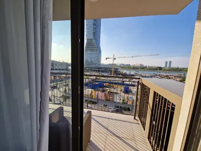 a room with a balcony with a view of a city at Aqua Royal BW apartment in Sajmište