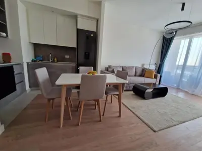 a kitchen and living room with a table and chairs at Aqua Royal BW apartment in Sajmište