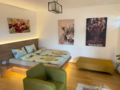 a small room with a bed and a couch at Vrtovi Ceraka in Belgrade
