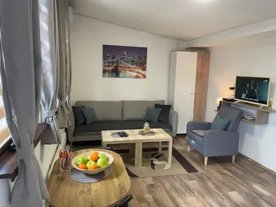 a living room with a couch and a table at Apartman Una in Batajnica