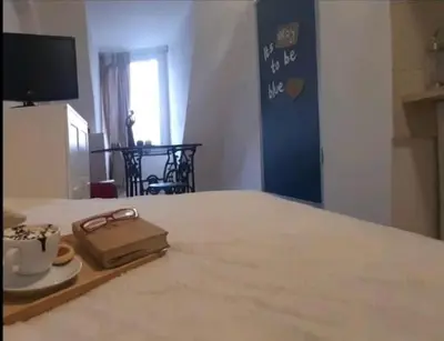 a room with a bed with a tray with a cup of coffee at Srce Beograda in Belgrade