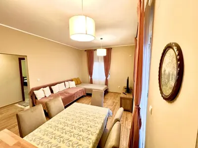 a living room with a table and a couch at RoomsApartments PopCOURT Tenis Centar in Pančevo