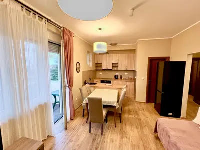 a kitchen and dining room with a table and chairs at RoomsApartments PopCOURT Tenis Centar in Pančevo