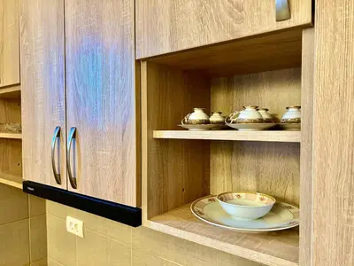a cabinet with a plate and bowls in it at RoomsApartments PopCOURT Tenis Centar in Pančevo