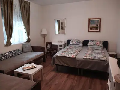 a living room with two beds and a couch at RoomsApartments PopCOURT Tenis Centar in Pančevo