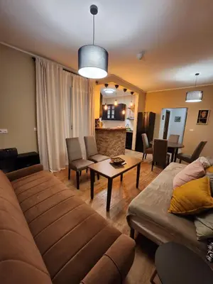 a living room with a couch and a table at RoomsApartments PopCOURT Tenis Centar in Pančevo