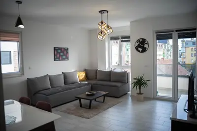 a living room with a couch and a table at Apartman Arija in Ruma