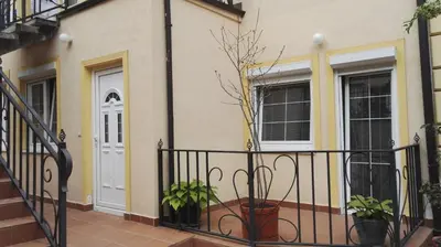a house with a gate and plants on a balcony at Fantastic Belgrade Nights in Belgrade