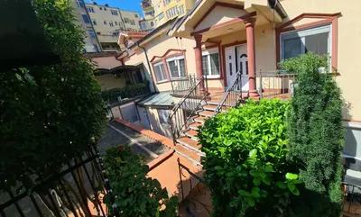 a house with stairs and plants in front of it at Fantastic Belgrade Nights in Belgrade