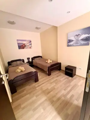 a large room with two beds and a table at Fantastic Belgrade Nights in Belgrade