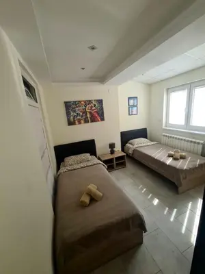 a bedroom with two beds and a window at Fantastic Belgrade Nights in Belgrade