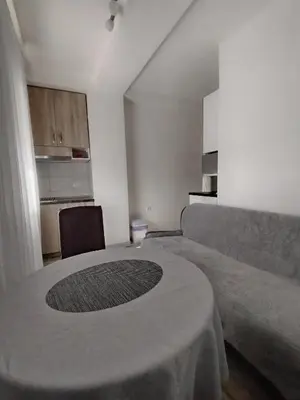 a living room with a table and a couch at Meli apartman in Smederevo
