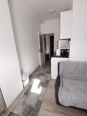 a living room with a couch and a kitchen at Meli apartman in Smederevo