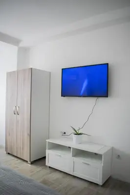 a living room with a tv on a white wall at Meli apartman in Smederevo