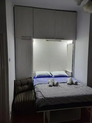 a bed in a room with two towels on it at Kod Vuka in Belgrade