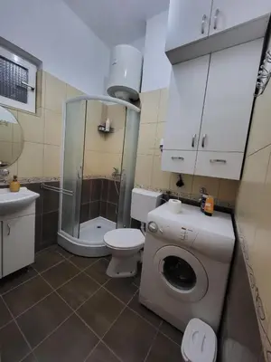 a bathroom with a shower and a toilet and a sink at Kod Vuka in Belgrade
