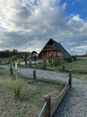 a barn with a fence in front of it at Vikendica sa bazenom u blizini Beograda in Veliki Borak