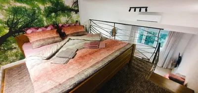 a bedroom with a large bed with a large window at Fantasy Apartment in Belgrade