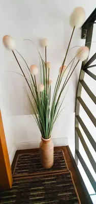 a plant in a vase sitting on a floor at Fantasy Apartment in Belgrade