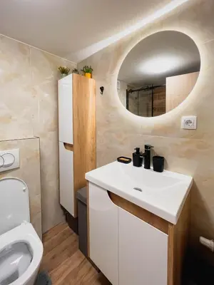 a bathroom with a white sink and a toilet at Fantasy Apartment in Belgrade