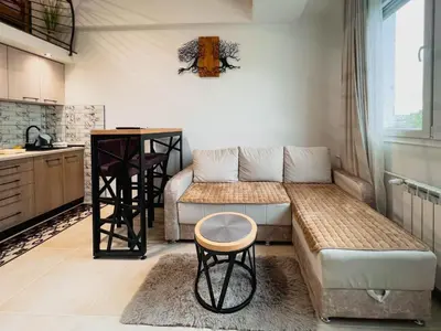 a living room with a couch and a table at Fantasy Apartment in Belgrade
