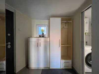 a bathroom with a white cabinet with a plant in it at White Bear 1663 Zemun Oldest House Apartment in Zemun