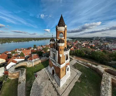 an aerial view of a tall tower with a city at White Bear 1663 Zemun Oldest House Apartment in Zemun