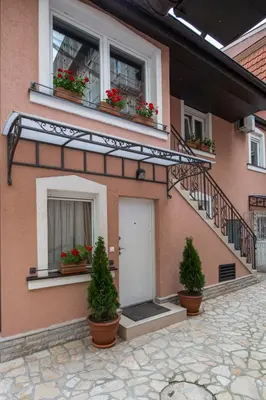 a building with potted plants on the side of it at Apartments Jevtic in Belgrade
