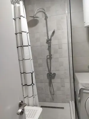 a shower with a glass door in a bathroom at KS Studio in Borča
