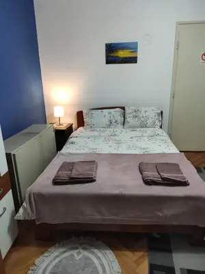 a bedroom with a bed with two towels on it at KS Studio in Borča