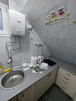 a small kitchen with a sink and a counter top at KS Studio in Borča