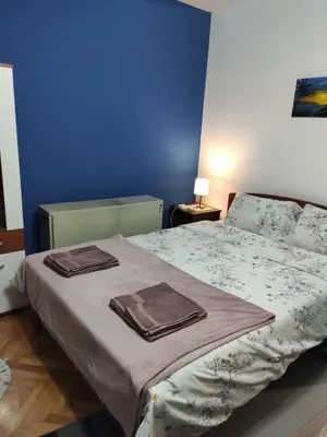 a bedroom with a bed with two towels on it at KS Studio in Borča