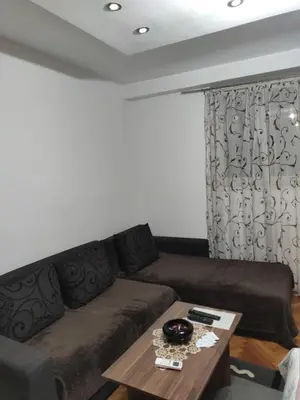 a living room with a couch and a coffee table at KS Studio in Borča