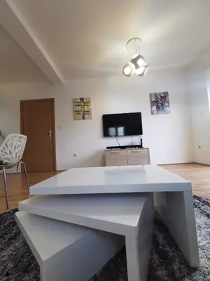 a white table in a living room with a tv at LoLa5 in Novi Grad
