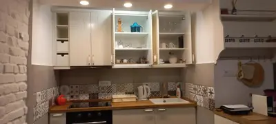 a kitchen with white cabinets and a sink at Botanic Garden 1 in Belgrade