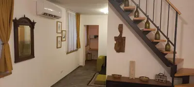 a hallway with a staircase with a mirror and a shelf at Botanic Garden 1 in Belgrade