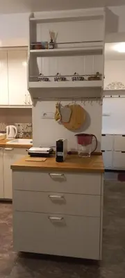 a kitchen with white cabinets and a wooden counter top at Botanic Garden 1 in Belgrade