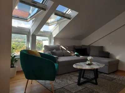 a living room with a couch and a table at Iris apartman in Arandjelovac