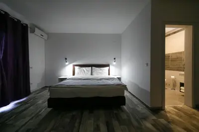 a bedroom with a bed in the middle of a room at Guesthouse & restaurant Tekovina in Smederevo