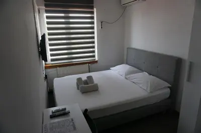 a small bed in a small room with a window at Guesthouse & restaurant Tekovina in Smederevo