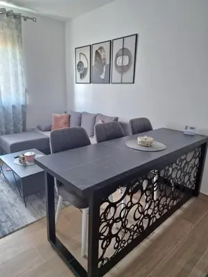 a living room with a table and a couch at lux two in Nova Pazova