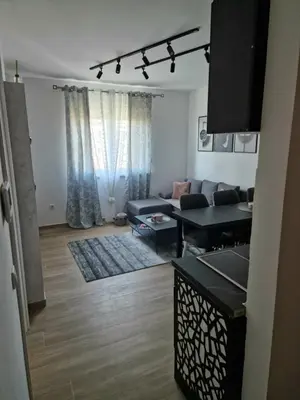 a living room with a couch and a table at lux two in Nova Pazova