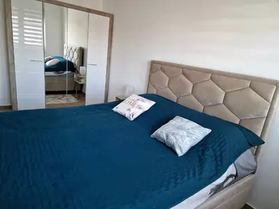 a bedroom with a blue bed with two pillows on it at lux two in Nova Pazova