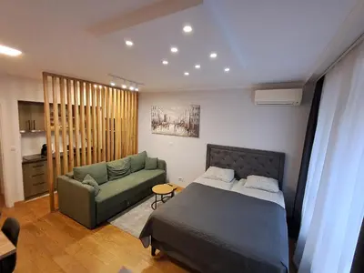 a bedroom with a bed and a couch at Apartment Premier 1 A Blok in Belgrade